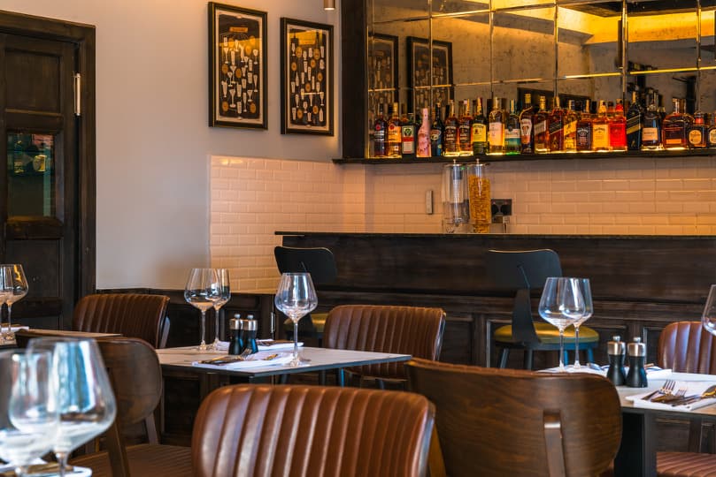 The Grill Room dining area with leather seating and wine wall